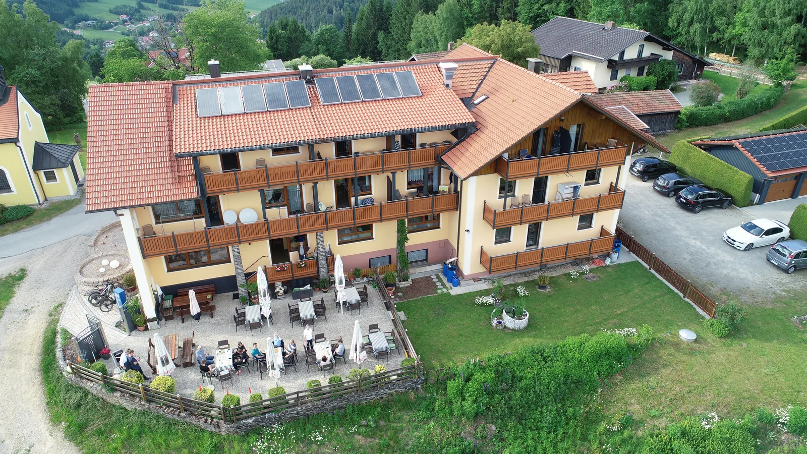 Luftaufnahme des Kolmsteiner Hofs mit Sonnenterrasse und Gästen